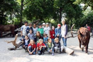 Children group with zoorangers in donkey enclosure